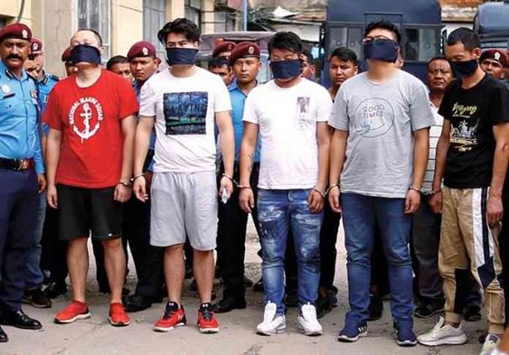 Five Chinese hackers whom were arrested for stealing millions of rupees from various ATM booths are displayed to the media inside the Police Station in Kathmandu on Sunday. Photo/Skanda Gautam/ THT